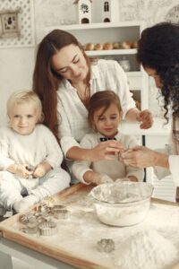 Family gathered in the kitchen baking together